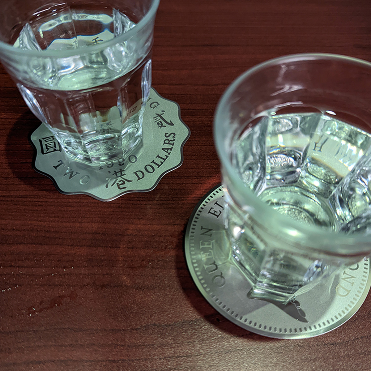 Queen Elizabeth II Coin Coaster being used on 2 glasses of water